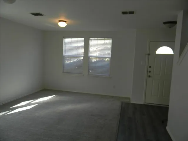 en empty room with windows and closet