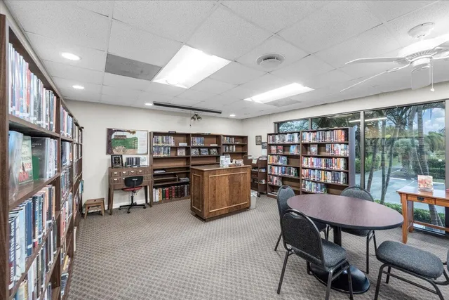 a dining room with furniture and a book shelf