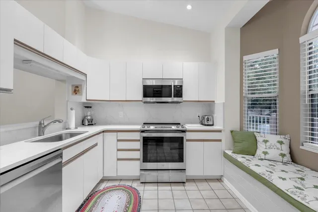 a kitchen with a sink stove and microwave
