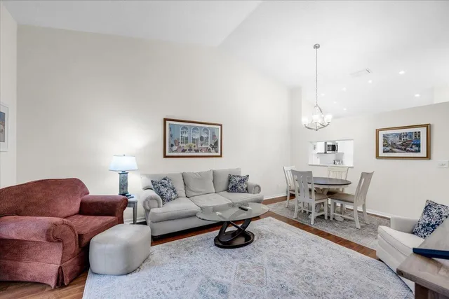 a living room with furniture a rug and white walls