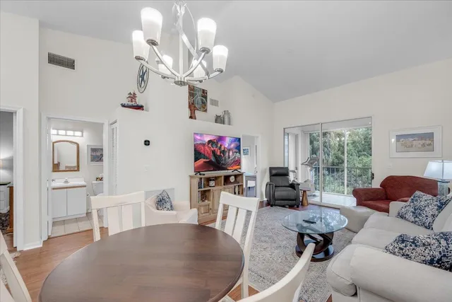 a living room with furniture a flat screen tv and a large window