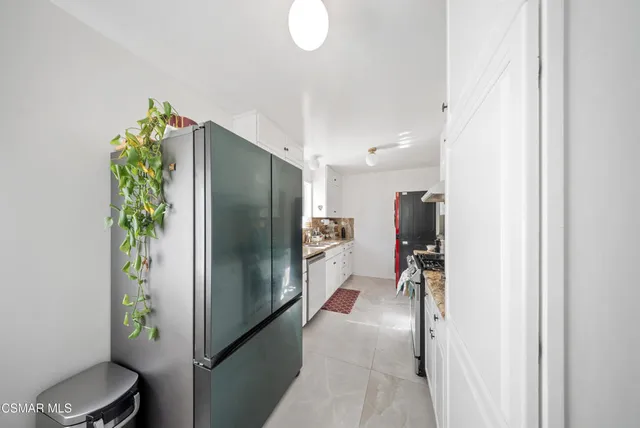 a kitchen with stainless steel appliances a refrigerator and a sink