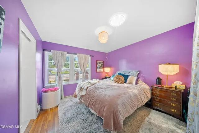 a bed room with a bed and a large window