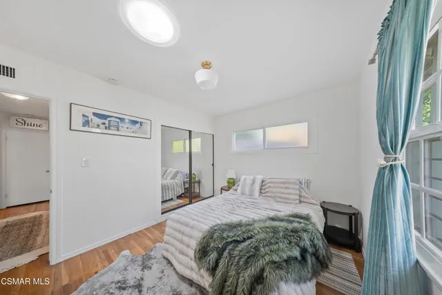 a bedroom with a bed and a dresser