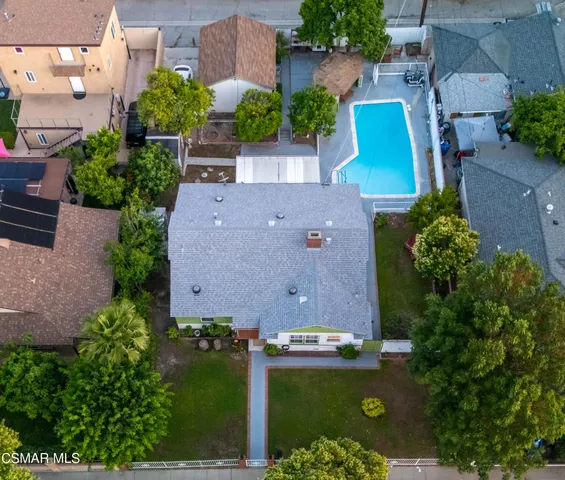 an aerial view of a house with garden space and street view