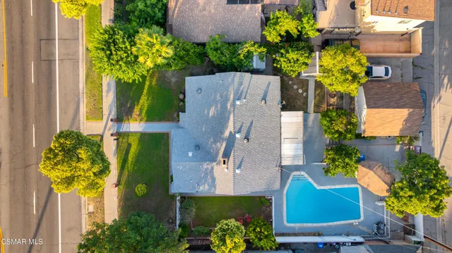 an aerial view of a house with a yard
