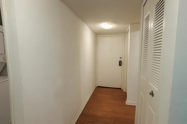 a view of a hallway with wooden floor