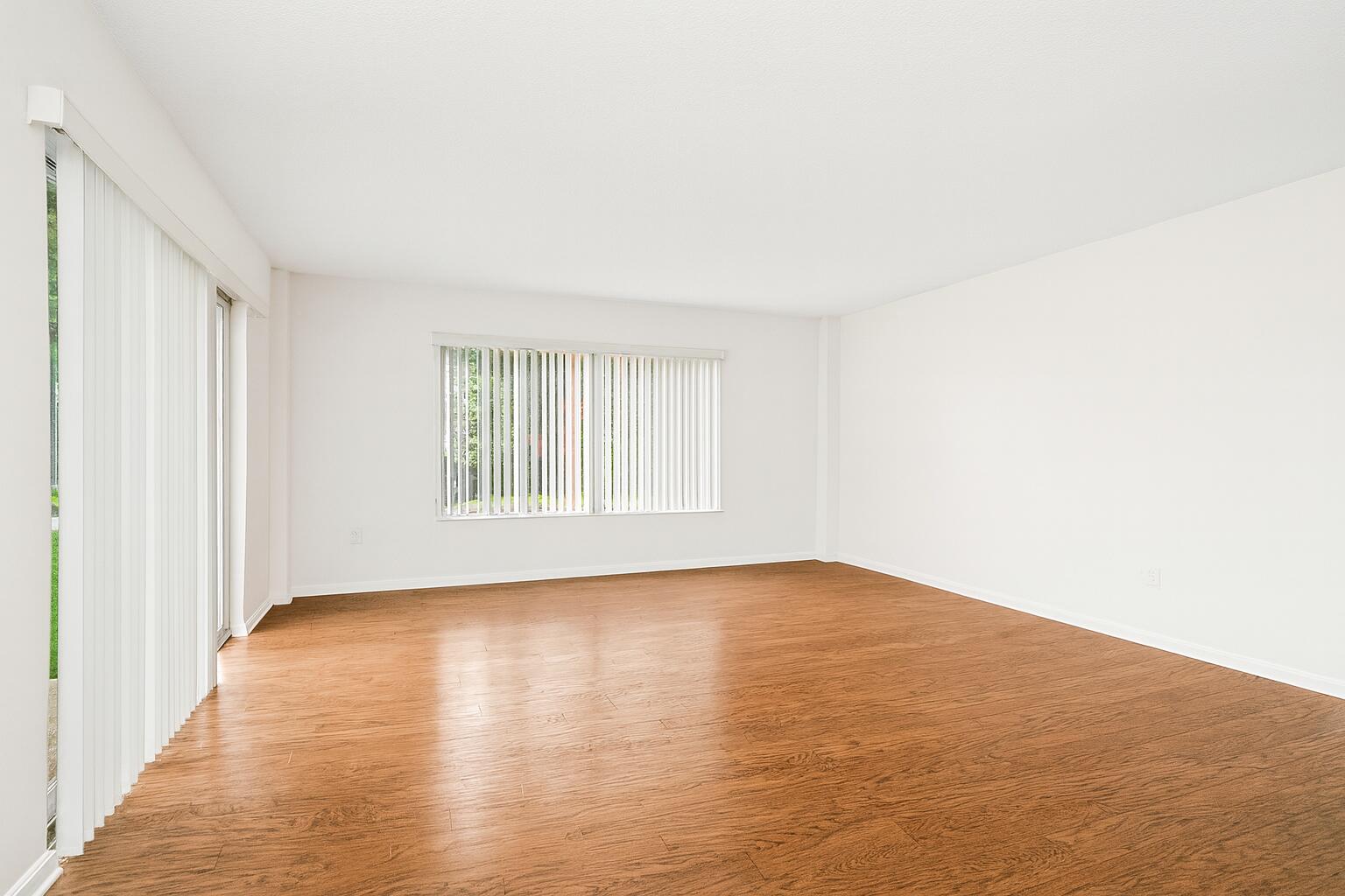 4174 Inverrary Drive, Unit 102 Lauderhill, FL 33319 - Photo 2 of 10 a view of an empty room with wooden floor and a window