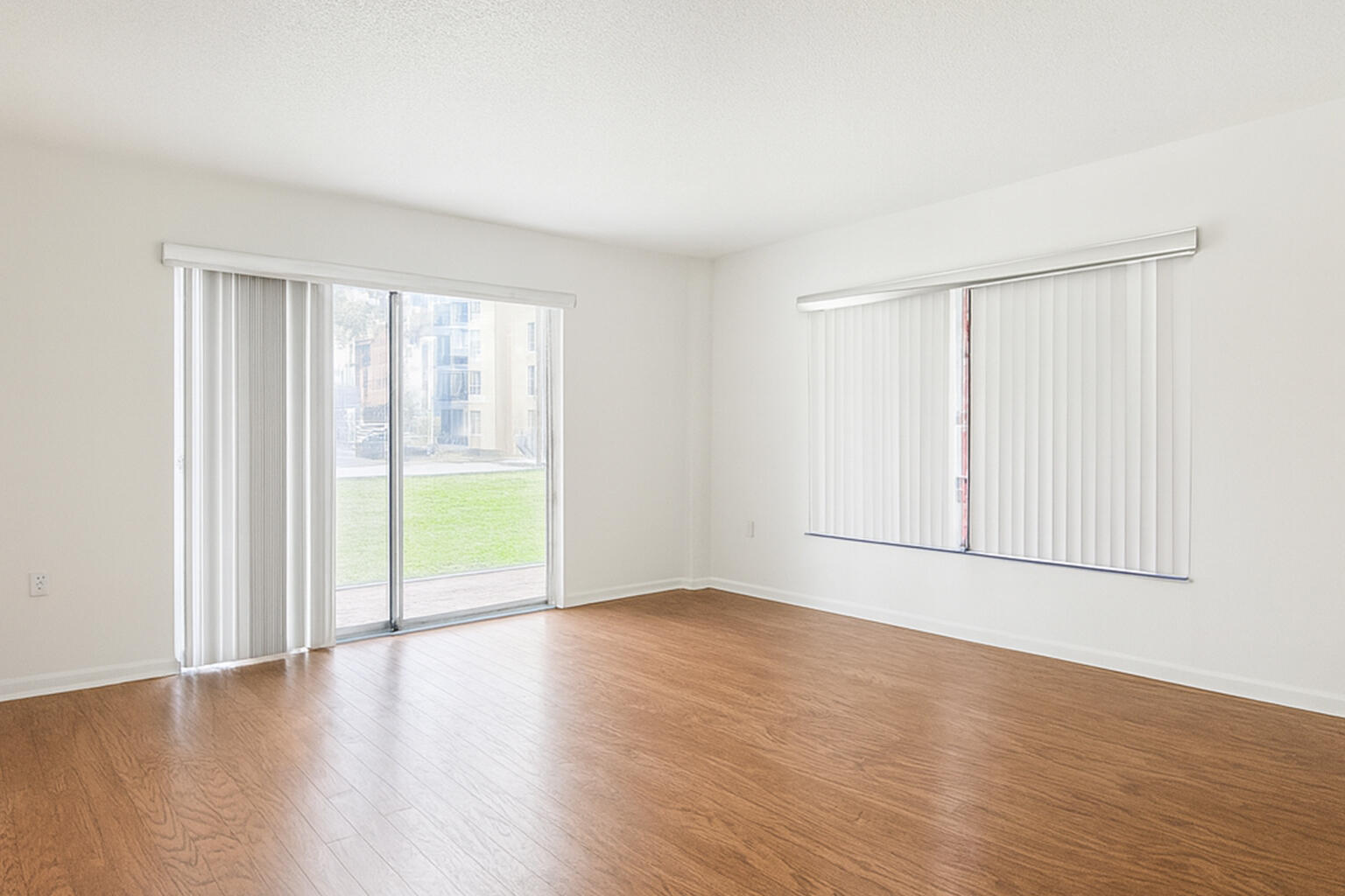 4174 Inverrary Drive, Unit 102 Lauderhill, FL 33319 - Photo 3 of 10 a view of an empty room with wooden floor and a window