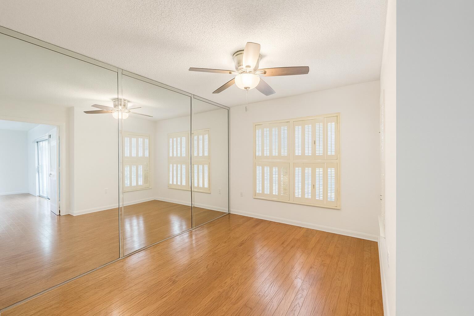4174 Inverrary Drive, Unit 102 Lauderhill, FL 33319 - Photo 4 of 10 a view of an empty room with wooden floor and a window