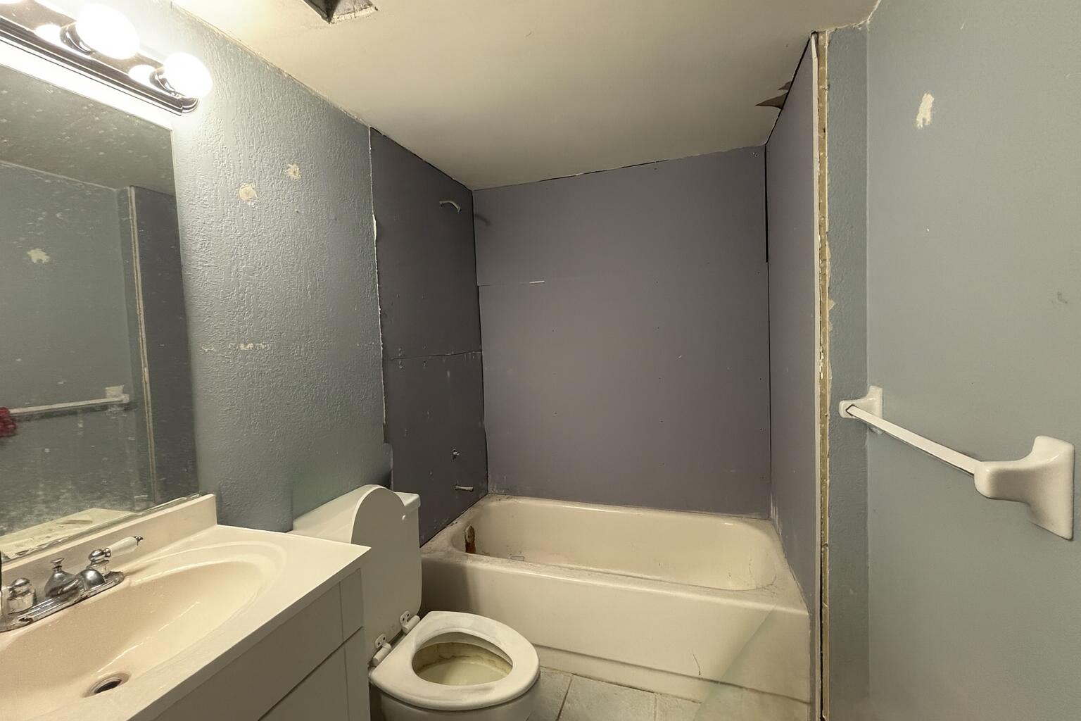 4174 Inverrary Drive, Unit 102 Lauderhill, FL 33319 - Photo 10 of 10 a bathroom with a sink a toilet and bathtub