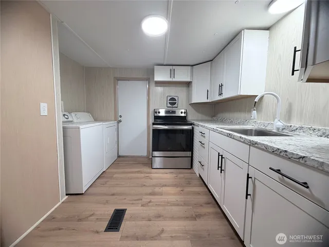a kitchen with granite countertop a sink and a stove