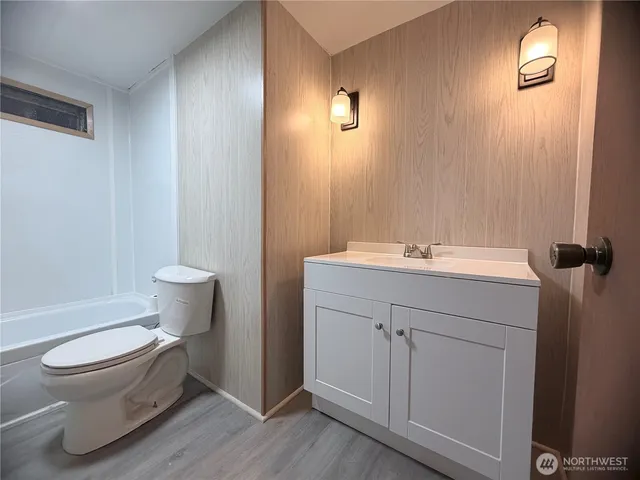 a bathroom with a sink toilet and vanity