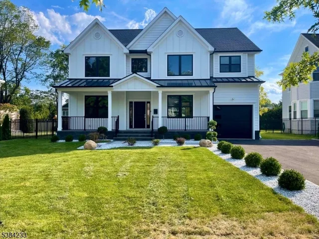 a front view of a house with yard and garage