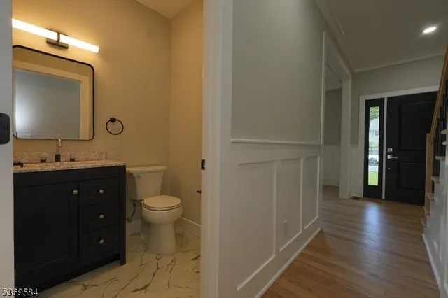 a bathroom with a toilet a sink and mirror