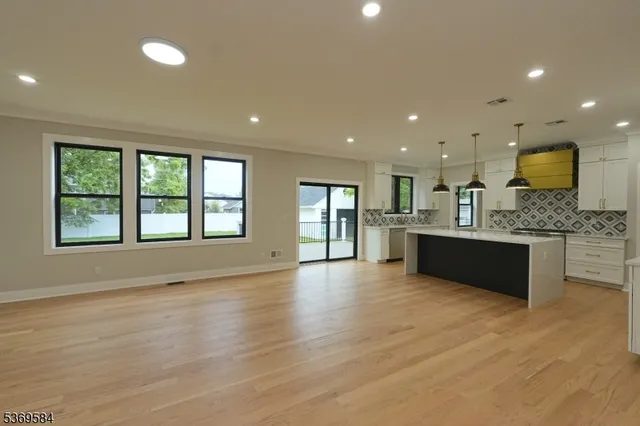 a large kitchen with a large window in it and kitchen island