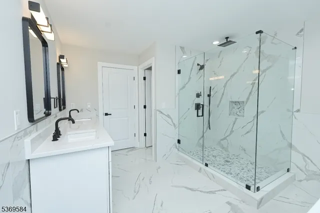 a bathroom with a shower sink and mirror