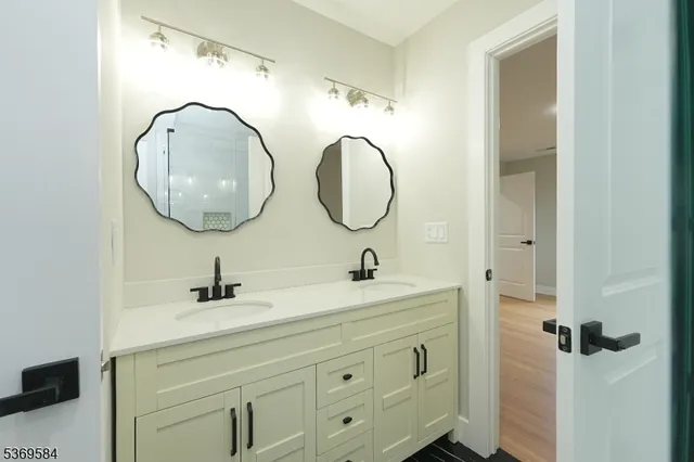 a bathroom with a sink a mirror and a light fixture