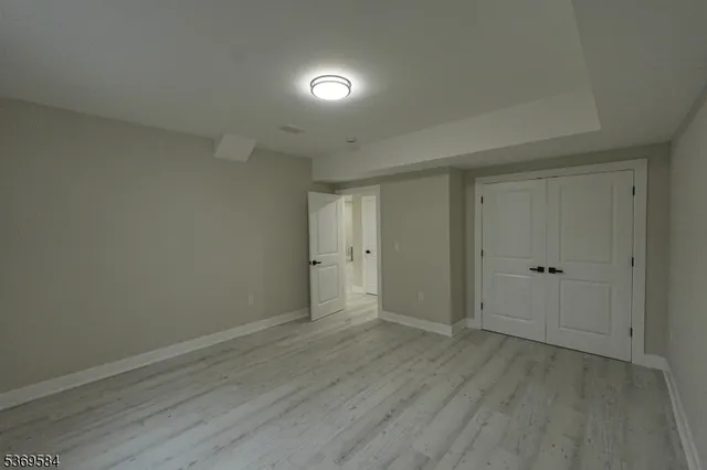 a view of an empty room and wooden floor