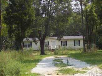 5280 Woodsdale Road Roxboro, NC 27574 - Photo 1 of 1 front view of house with a yard