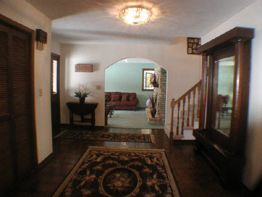 11624 Bend River Road Roscoe, IL 61073 - Photo 11 of 11 a view of a hallway with wooden floor windows and a livingroom