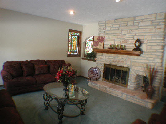 11624 Bend River Road Roscoe, IL 61073 - Photo 4 of 11 a living room with furniture and a fireplace