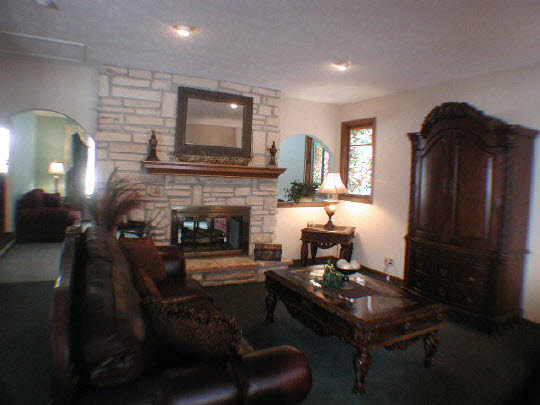 11624 Bend River Road Roscoe, IL 61073 - Photo 5 of 11 a living room with furniture and a fireplace