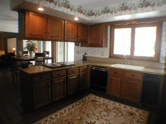 11624 Bend River Road Roscoe, IL 61073 - Photo 7 of 11 a kitchen with stainless steel appliances granite countertop a sink dishwasher stove and cabinets