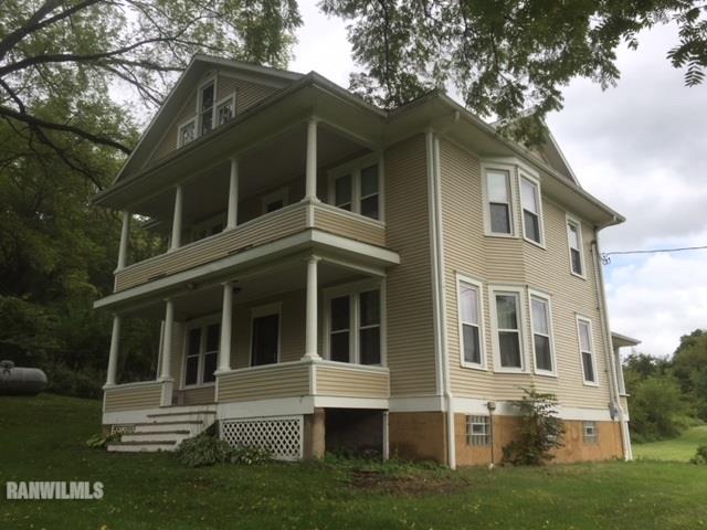 1027 South Apple River Road Elizabeth, IL 61028 - Photo 1 of 25 a front view of a house with a garden