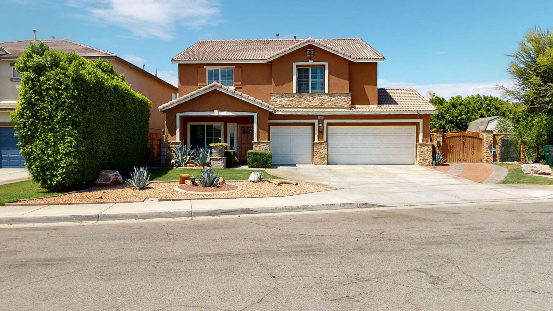83680 Glendora Ridge Avenue Coachella, CA 92236 - Photo 1 of 32 a front view of a house with a yard