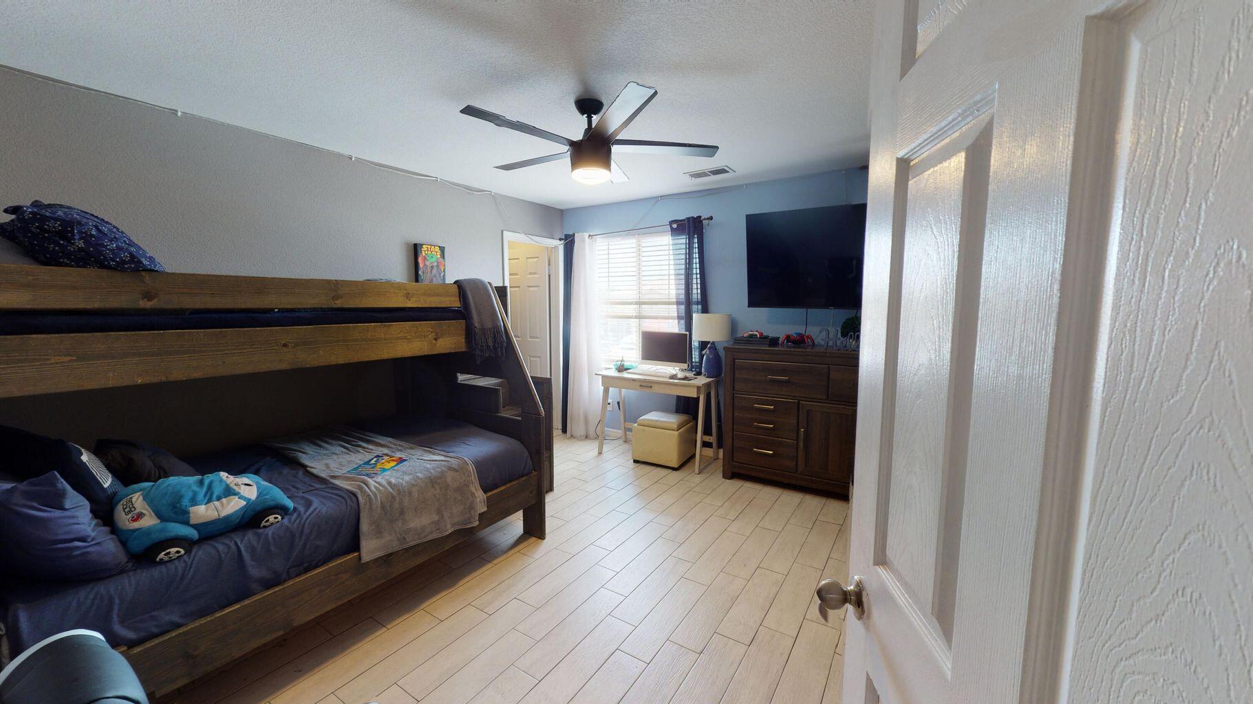 83680 Glendora Ridge Avenue Coachella, CA 92236 - Photo 12 of 32 a bedroom with furniture and a wooden floor