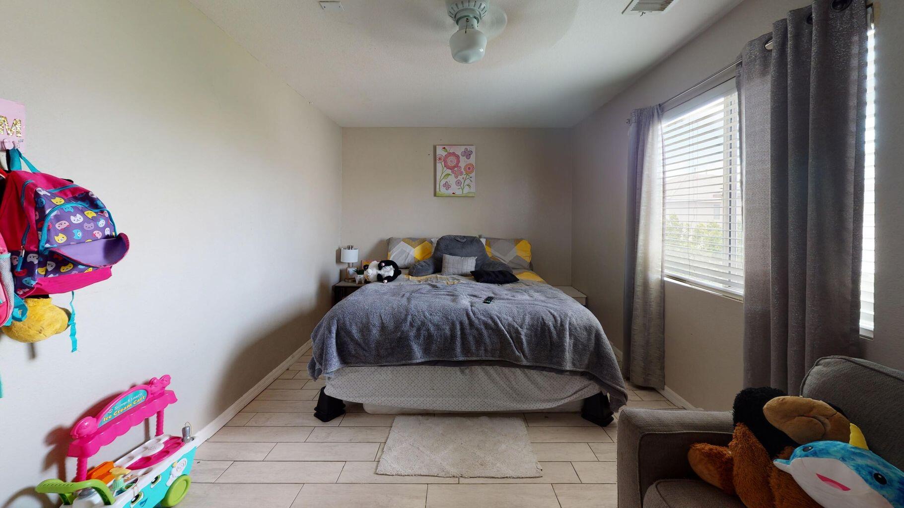 83680 Glendora Ridge Avenue Coachella, CA 92236 - Photo 16 of 32 a bedroom with a bed and window