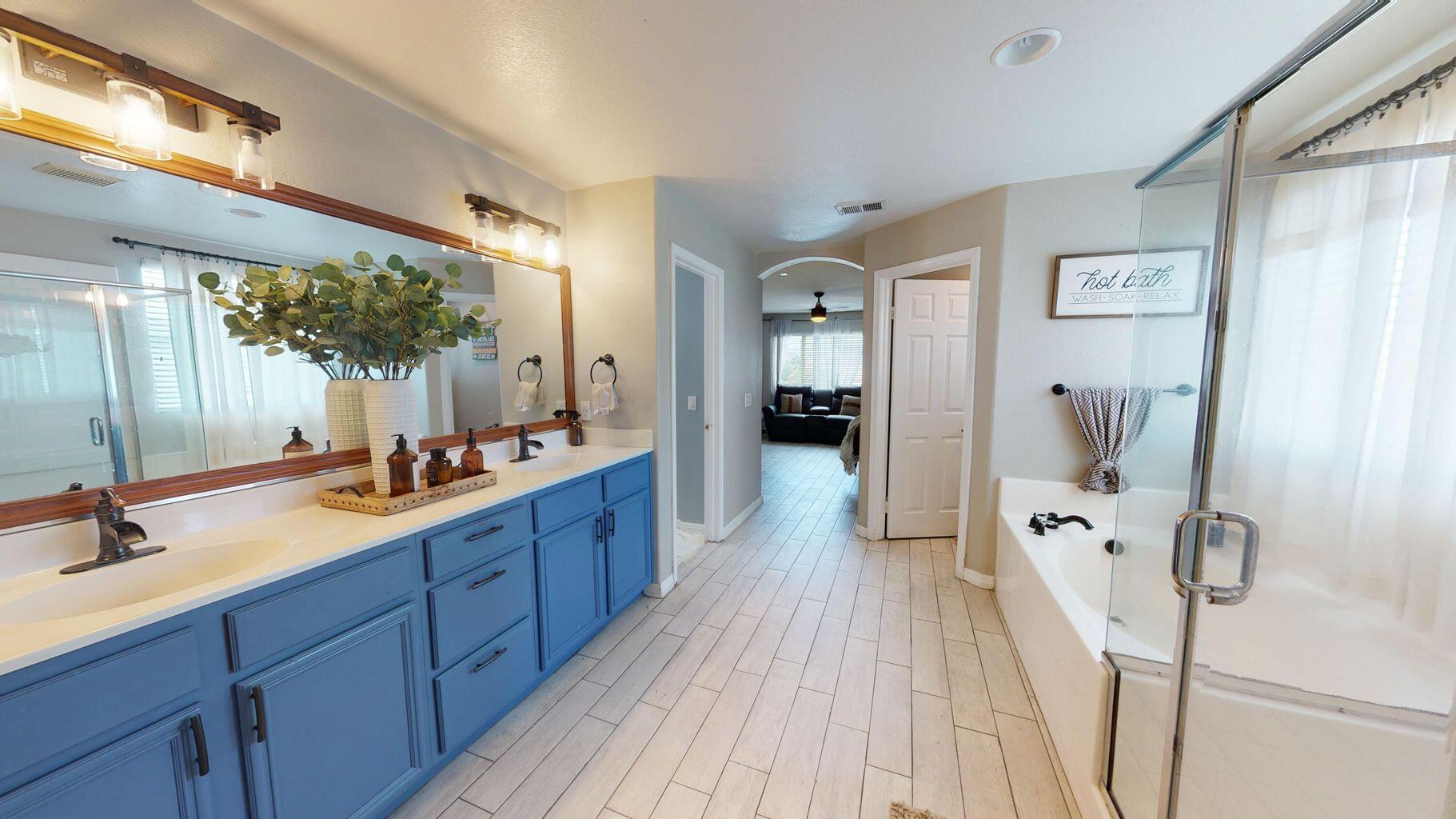 83680 Glendora Ridge Avenue Coachella, CA 92236 - Photo 18 of 32 a spacious bathroom with a double vanity sink a mirror and shower