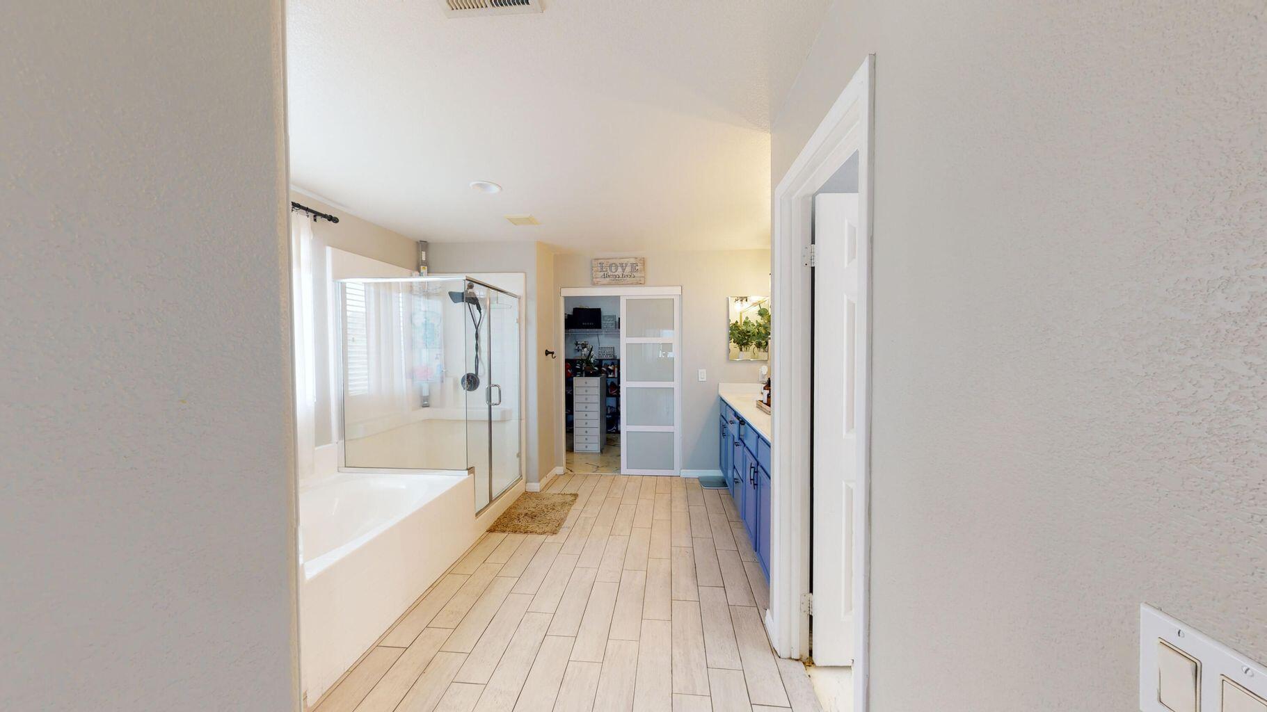 83680 Glendora Ridge Avenue Coachella, CA 92236 - Photo 21 of 32 a bathroom with a bathtub and a shower
