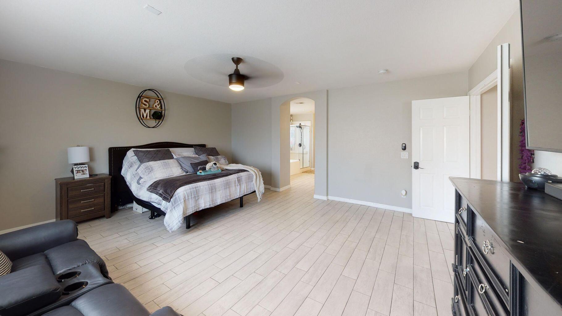 83680 Glendora Ridge Avenue Coachella, CA 92236 - Photo 23 of 32 a bedroom with a bed and a chandelier