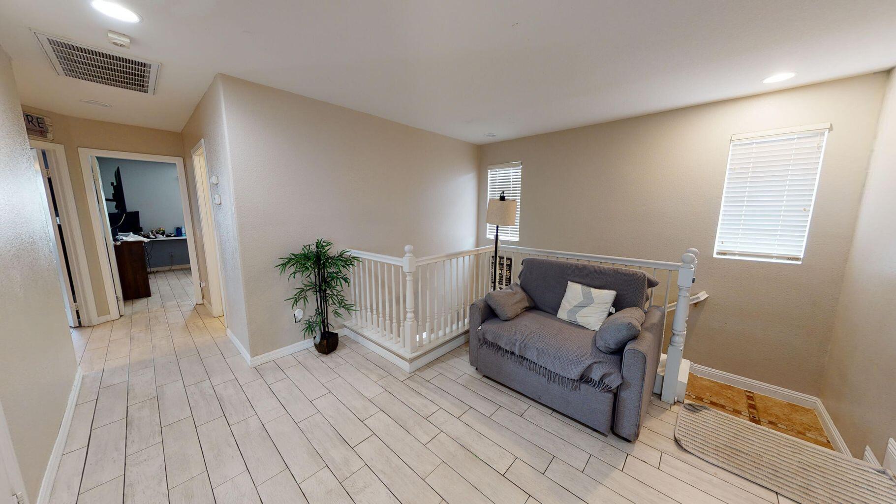 83680 Glendora Ridge Avenue Coachella, CA 92236 - Photo 25 of 32 a living room with furniture and a potted plant
