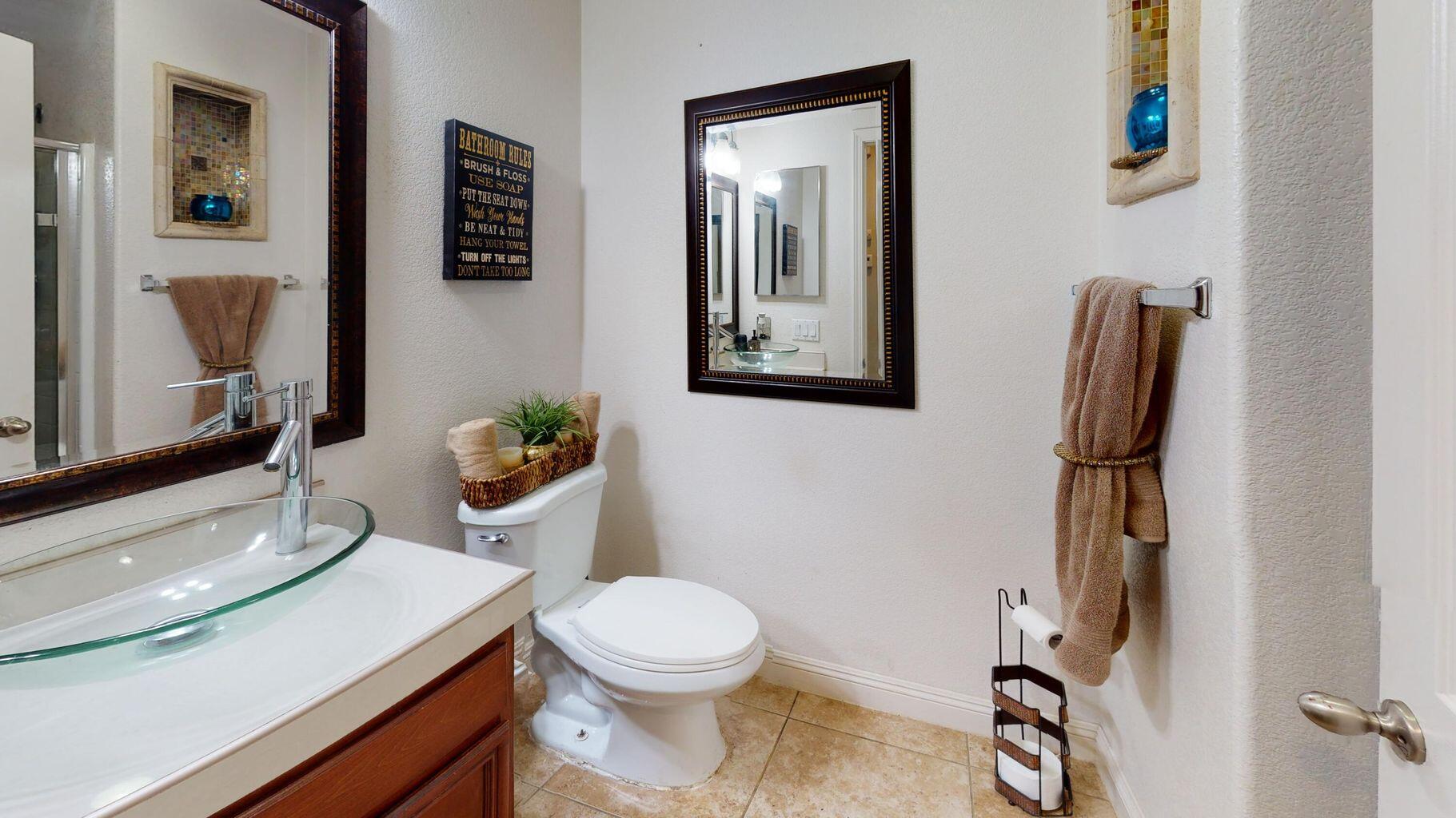 83680 Glendora Ridge Avenue Coachella, CA 92236 - Photo 26 of 32 a bathroom with a toilet sink and mirror