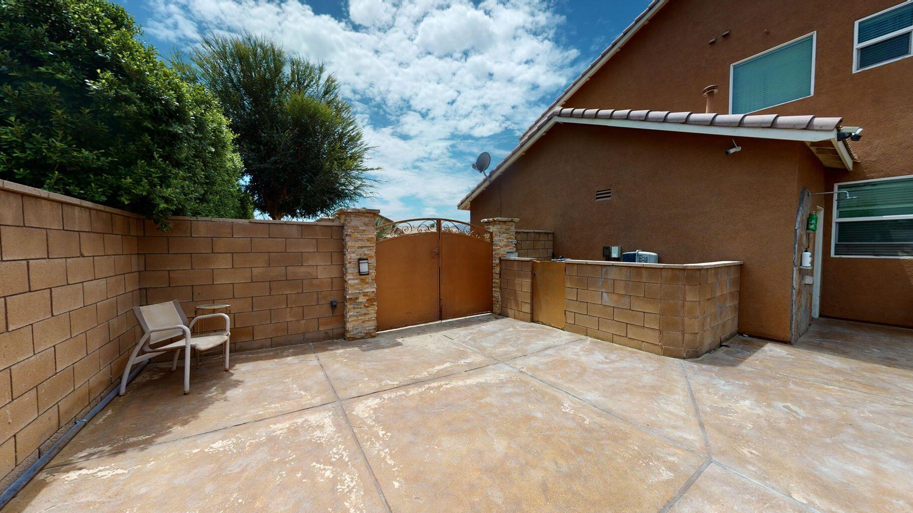 83680 Glendora Ridge Avenue Coachella, CA 92236 - Photo 28 of 32 a view of backyard with barbeque grill and wooden fence