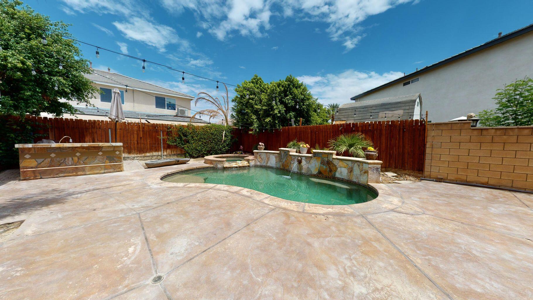 83680 Glendora Ridge Avenue Coachella, CA 92236 - Photo 29 of 32 a swimming pool with outdoor seating and yard