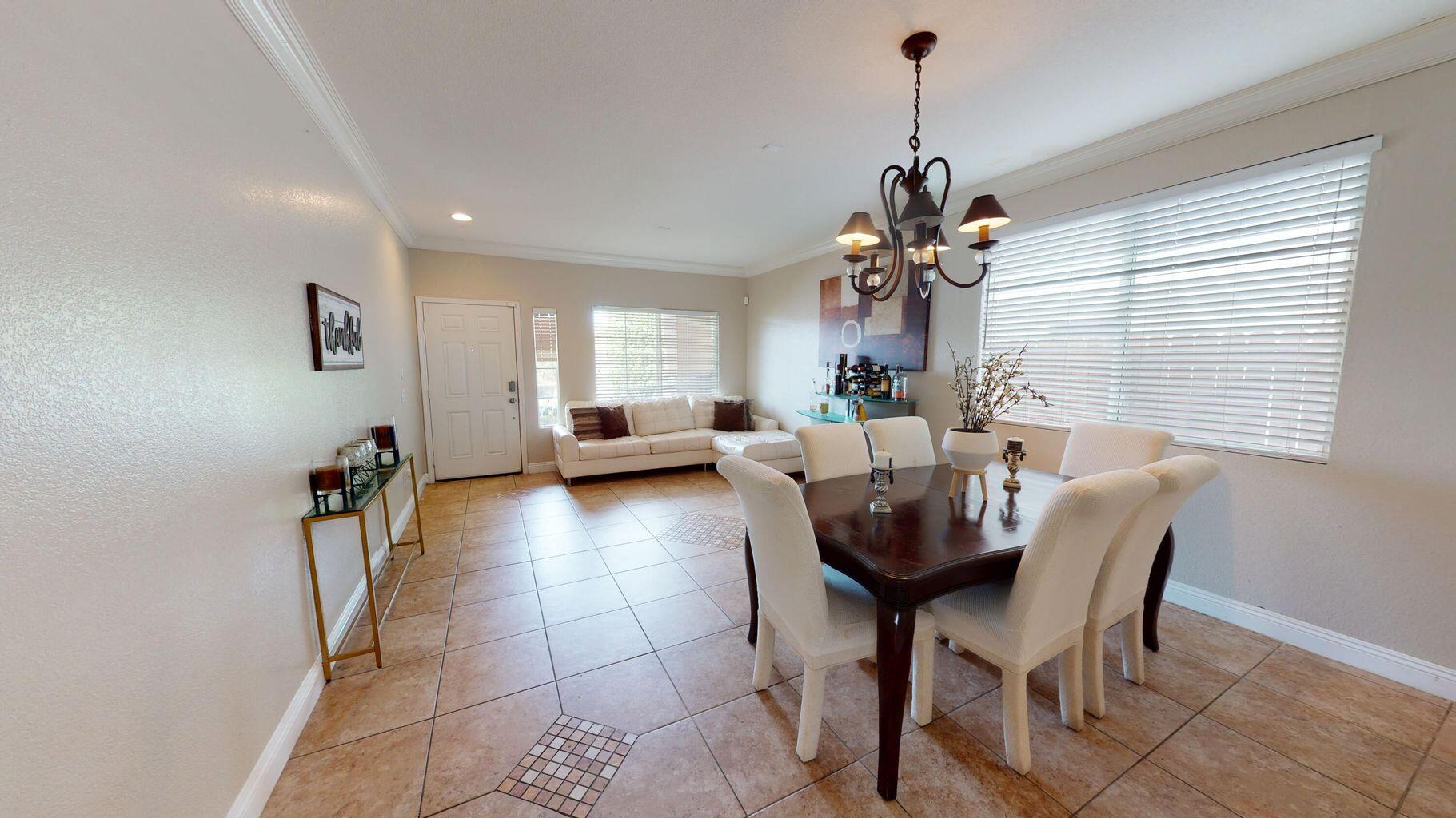 83680 Glendora Ridge Avenue Coachella, CA 92236 - Photo 3 of 32 a view of a dining room with furniture and chandelier