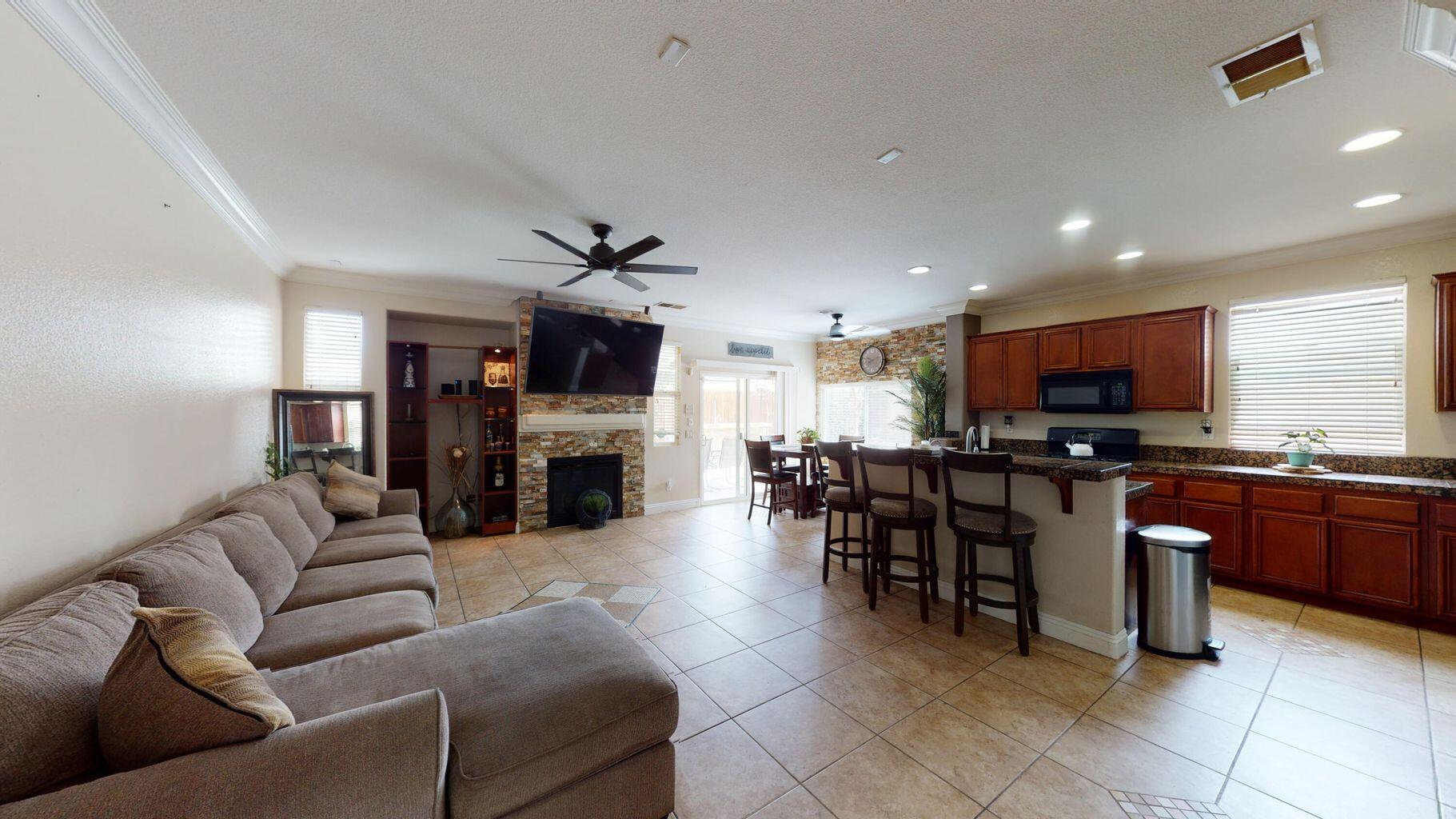 83680 Glendora Ridge Avenue Coachella, CA 92236 - Photo 5 of 32 a living room with furniture a flat screen tv and kitchen view