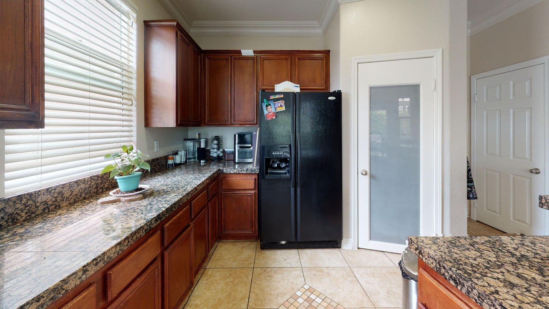 83680 Glendora Ridge Avenue Coachella, CA 92236 - Photo 8 of 32 a kitchen with stainless steel appliances granite countertop a refrigerator and a sink