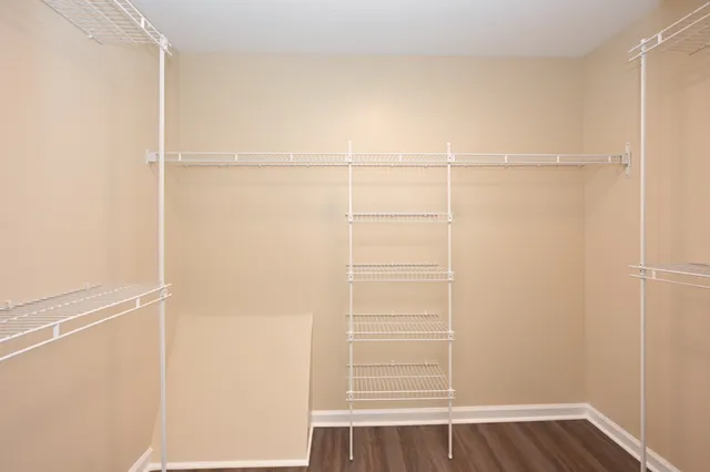 a view of a room with wooden floor