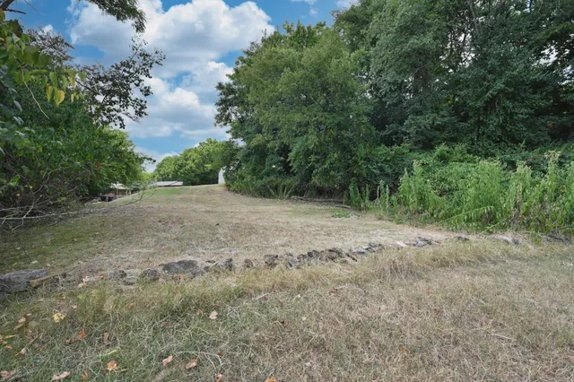 an aerial view of a house with a yard and lake view