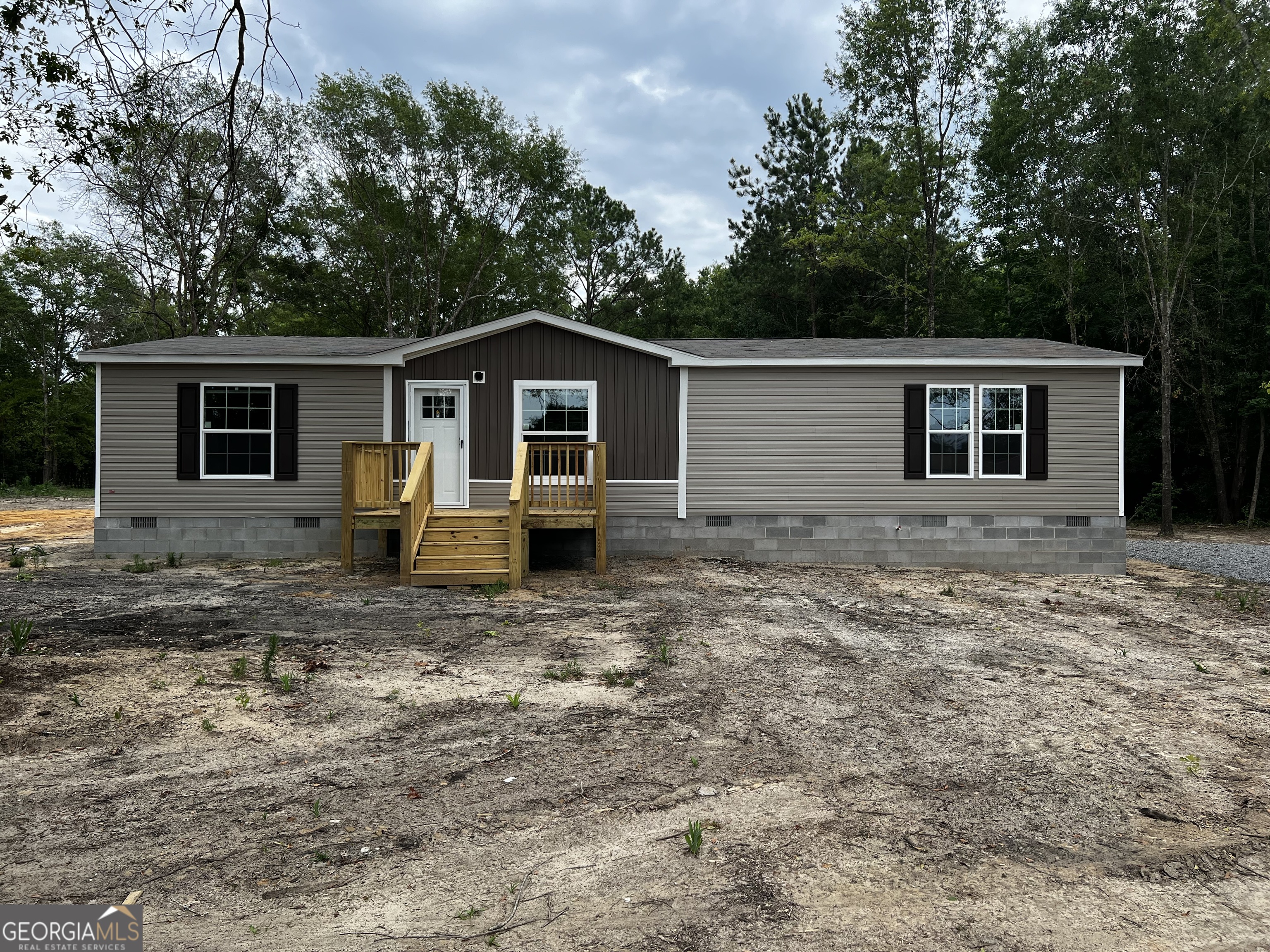 178 Rene Dr Extension Cochran, GA 31014 - Photo 1 of 1 a front view of a house with garden