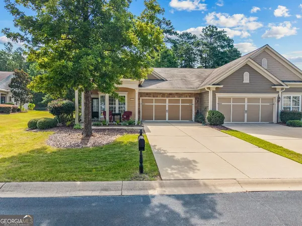 a view of house that has a yard