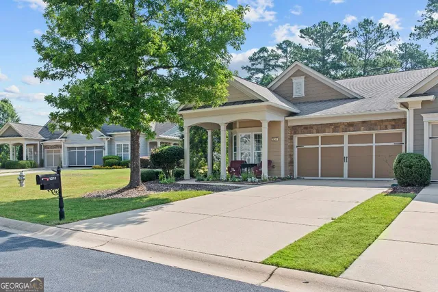 a view of a house with a yard and plants