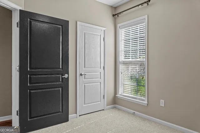a view of backyard with a large window and wooden floor