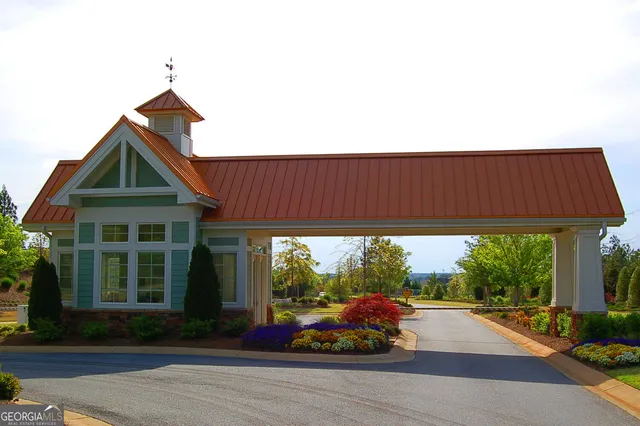 a view of a swimming pool with lawn chairs and a fire pit