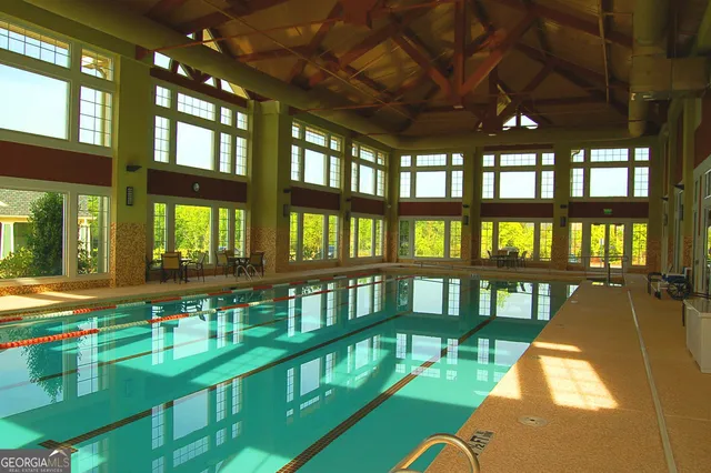 a view of a lake with a bench and trees around